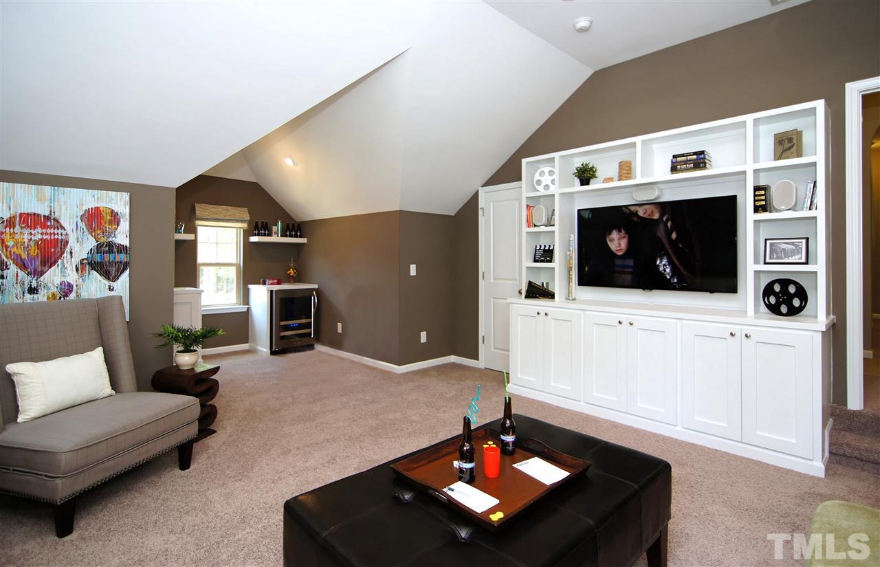 826 Wickham Ridge Road, Unit 6 Apex, NC 27539 - Photo 24 of 25 a living room with furniture and a flat screen tv