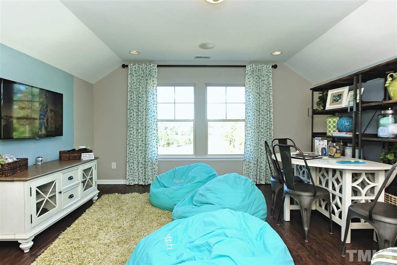 826 Wickham Ridge Road, Unit 6 Apex, NC 27539 - Photo 25 of 25 a living room with furniture and a flat screen tv