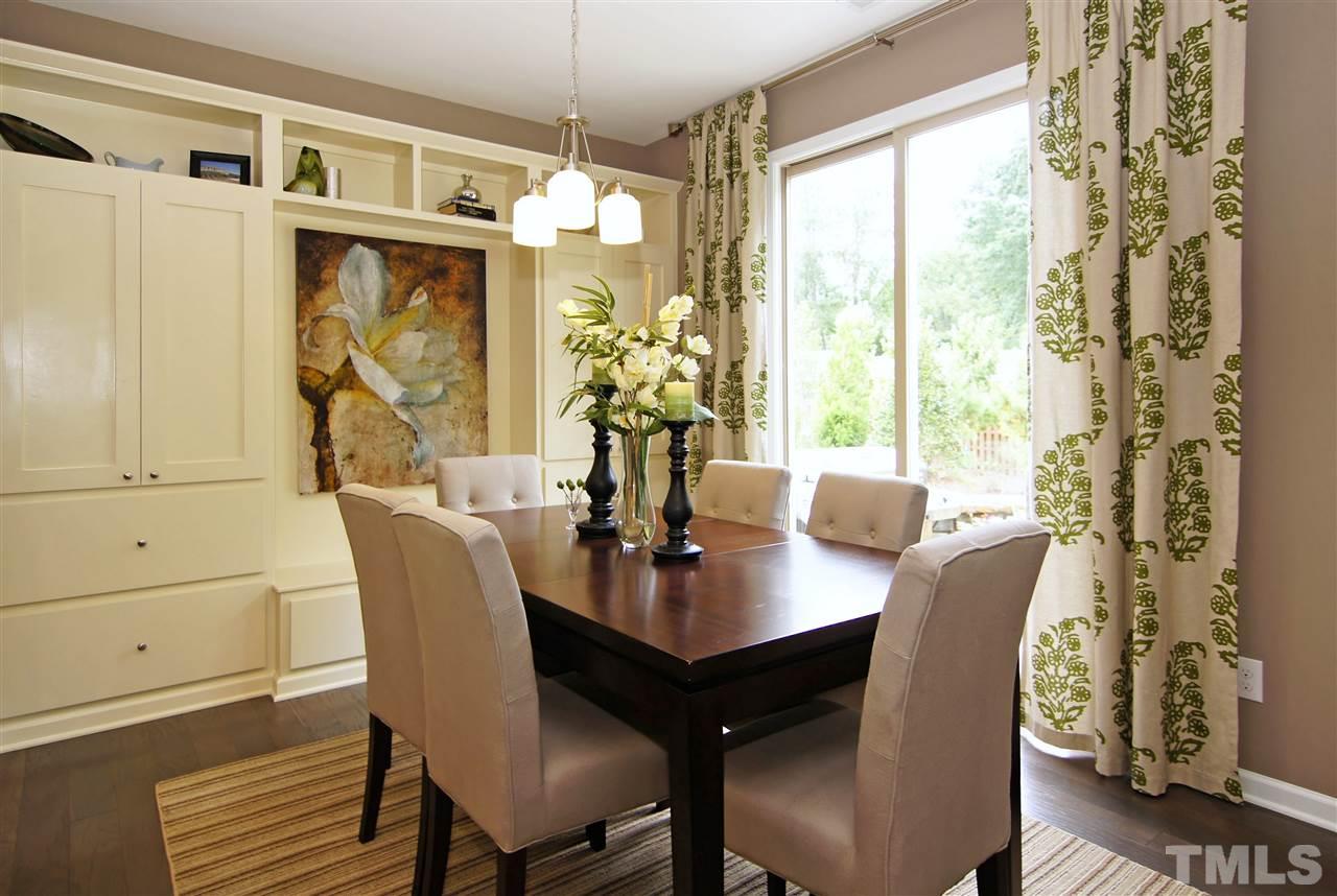 826 Wickham Ridge Road, Unit 6 Apex, NC 27539 - Photo 10 of 25 a view of a dining room with furniture wooden floor and chandelier