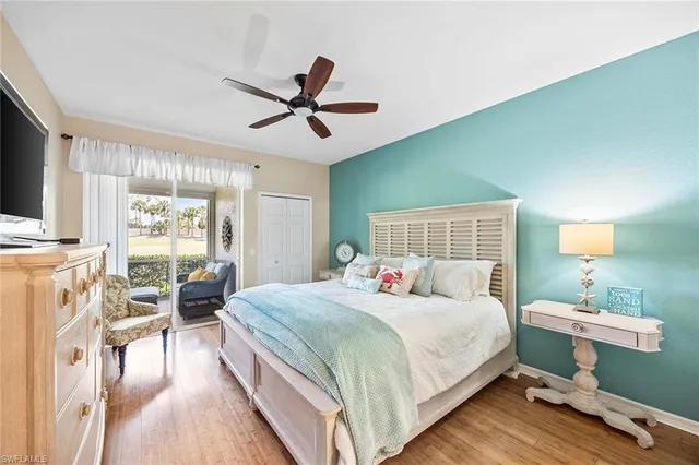 a bedroom with a bed a chandelier and a flat screen tv