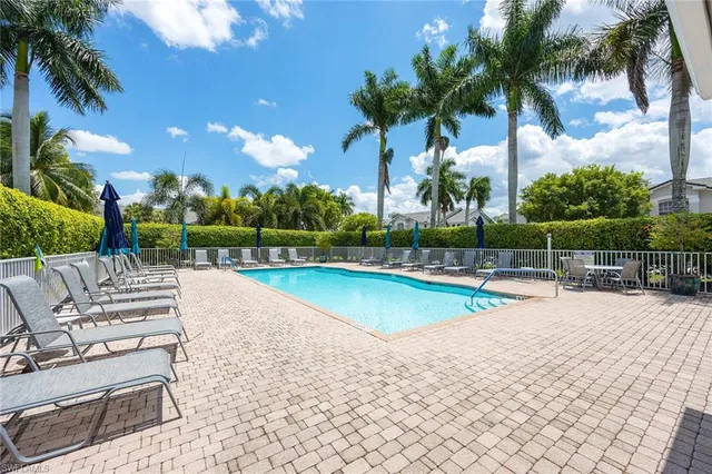 a view of a swimming pool with a patio and a garden
