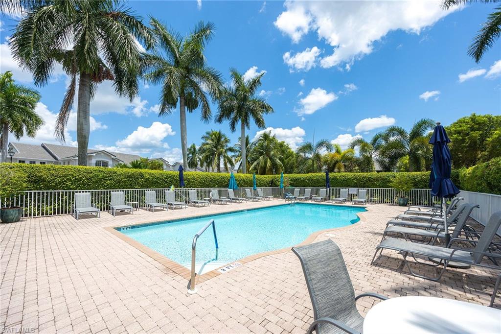 7000 Pinnacle Lane, Unit 1401 Naples, FL 34110 - Photo 25 of 49 a view of a swimming pool with a patio and a garden