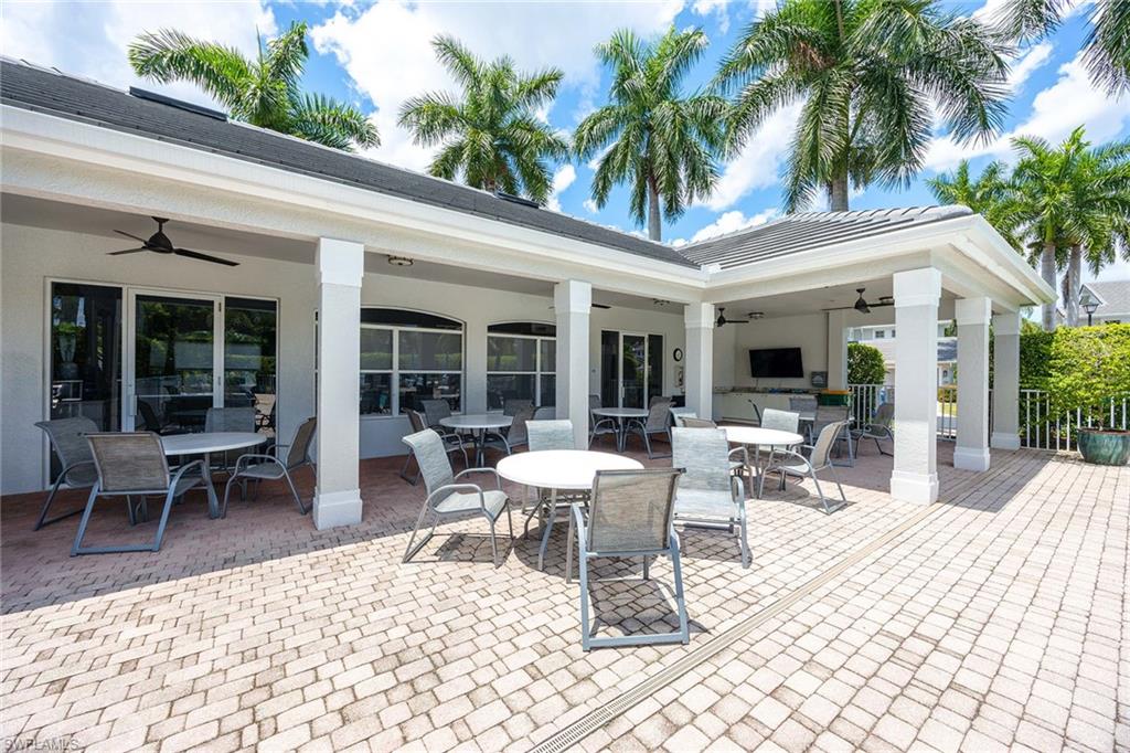 7000 Pinnacle Lane, Unit 1401 Naples, FL 34110 - Photo 26 of 49 a view of a dinning table and chairs in patio of the house