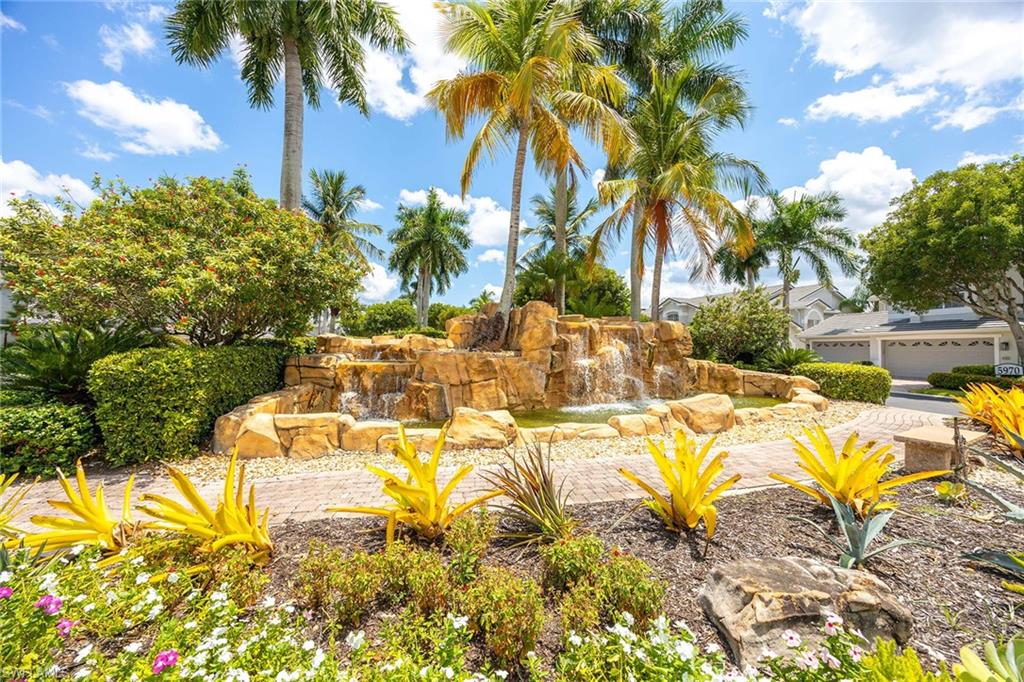 7000 Pinnacle Lane, Unit 1401 Naples, FL 34110 - Photo 27 of 49 a view of a swimming pool with a garden