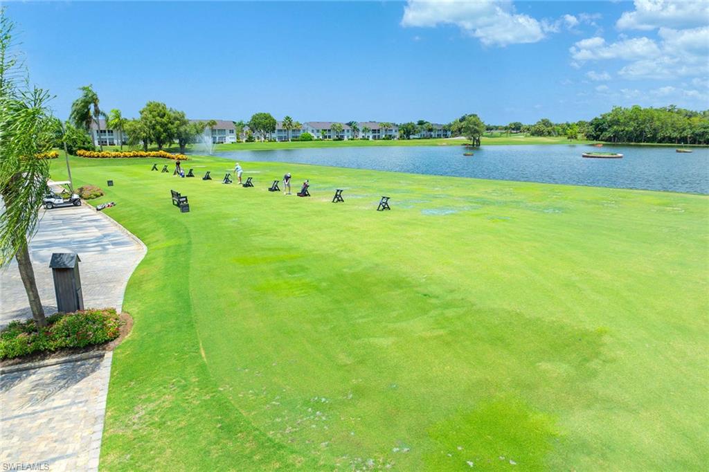7000 Pinnacle Lane, Unit 1401 Naples, FL 34110 - Photo 42 of 49 a view of a lake with houses in the background