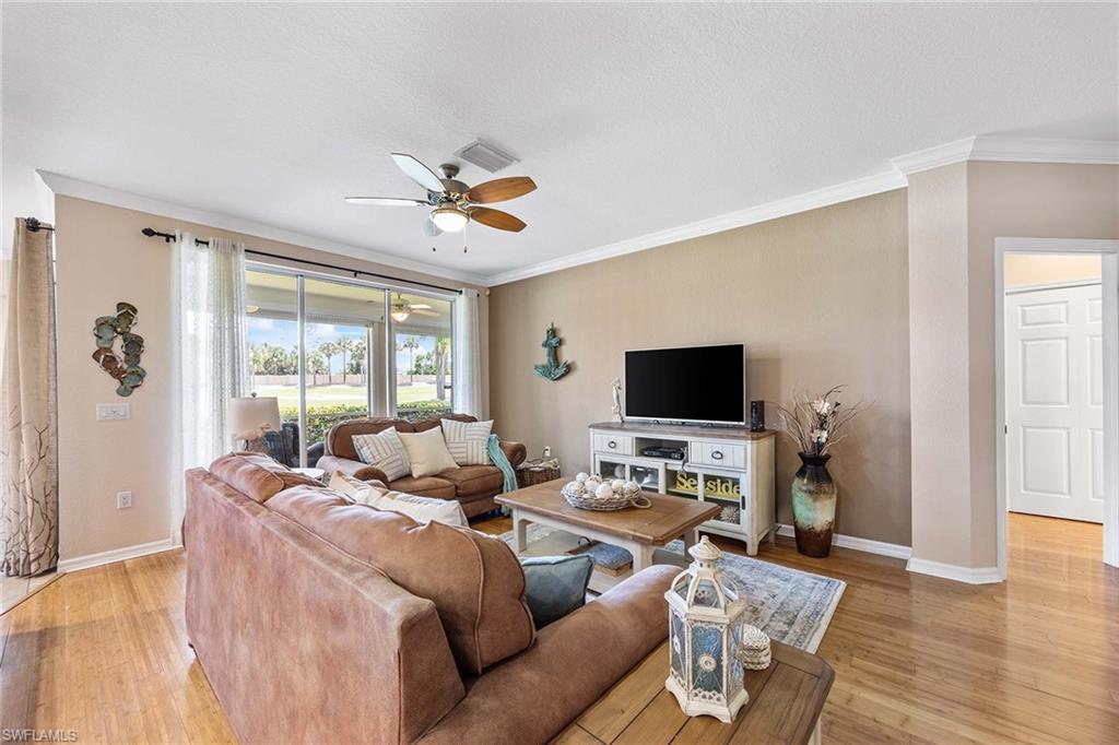 7000 Pinnacle Lane, Unit 1401 Naples, FL 34110 - Photo 5 of 49 a living room with furniture and a flat screen tv