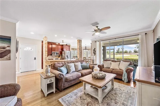 a living room with furniture a large window and a table