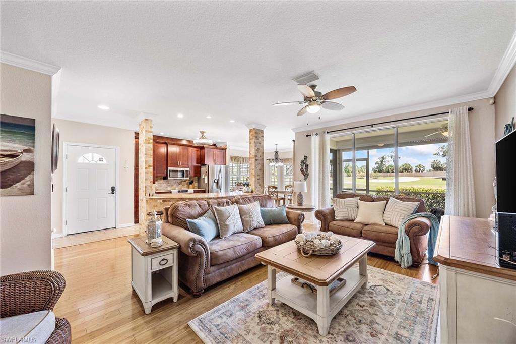 7000 Pinnacle Lane, Unit 1401 Naples, FL 34110 - Photo 6 of 49 a living room with furniture a large window and a table