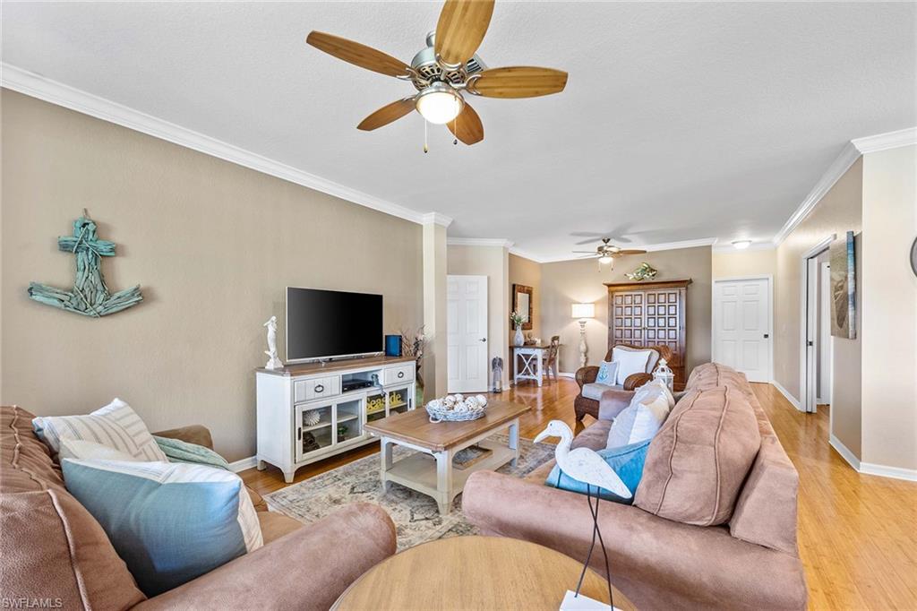 7000 Pinnacle Lane, Unit 1401 Naples, FL 34110 - Photo 7 of 49 a living room with furniture and a flat screen tv
