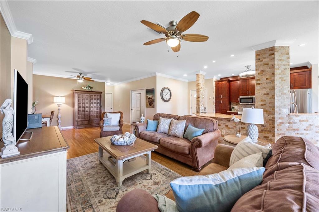 7000 Pinnacle Lane, Unit 1401 Naples, FL 34110 - Photo 8 of 49 a living room with furniture and a large window