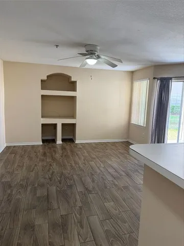 a kitchen with a refrigerator a stove top oven a sink and cabinets