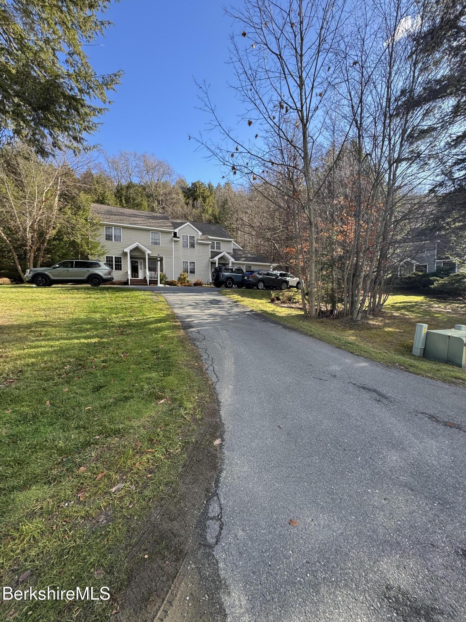 a front view of house with yard and trees