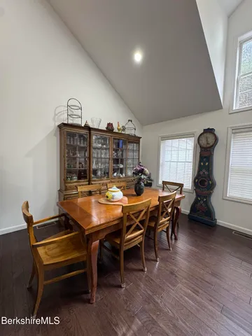 a room with furniture pool table and windows