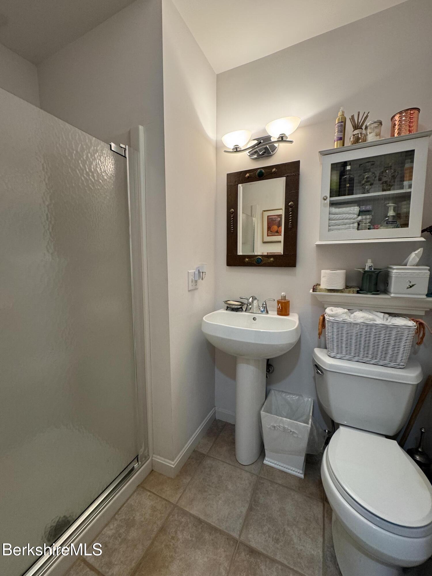 9102 Mountainside Drive Hancock, MA 01237 - Photo 12 of 31 a bathroom with a sink toilet and a mirror