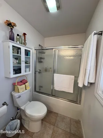 a bathroom with a toilet and shower