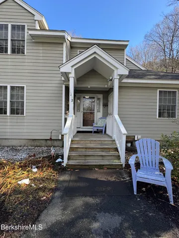 a view of a house with a yard and wooden floor