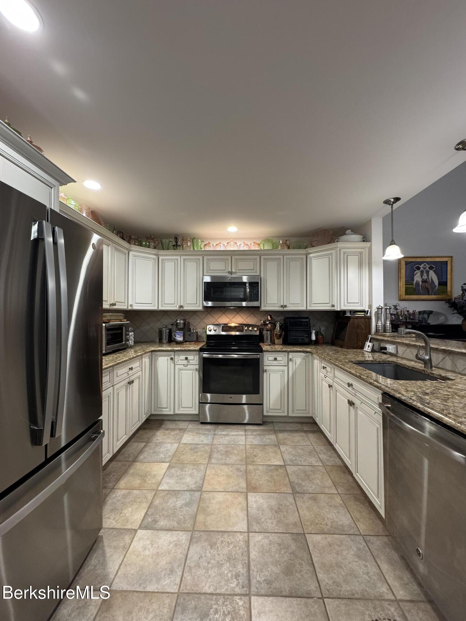 9102 Mountainside Drive Hancock, MA 01237 - Photo 6 of 31 a large kitchen with a stove top oven a sink and cabinets