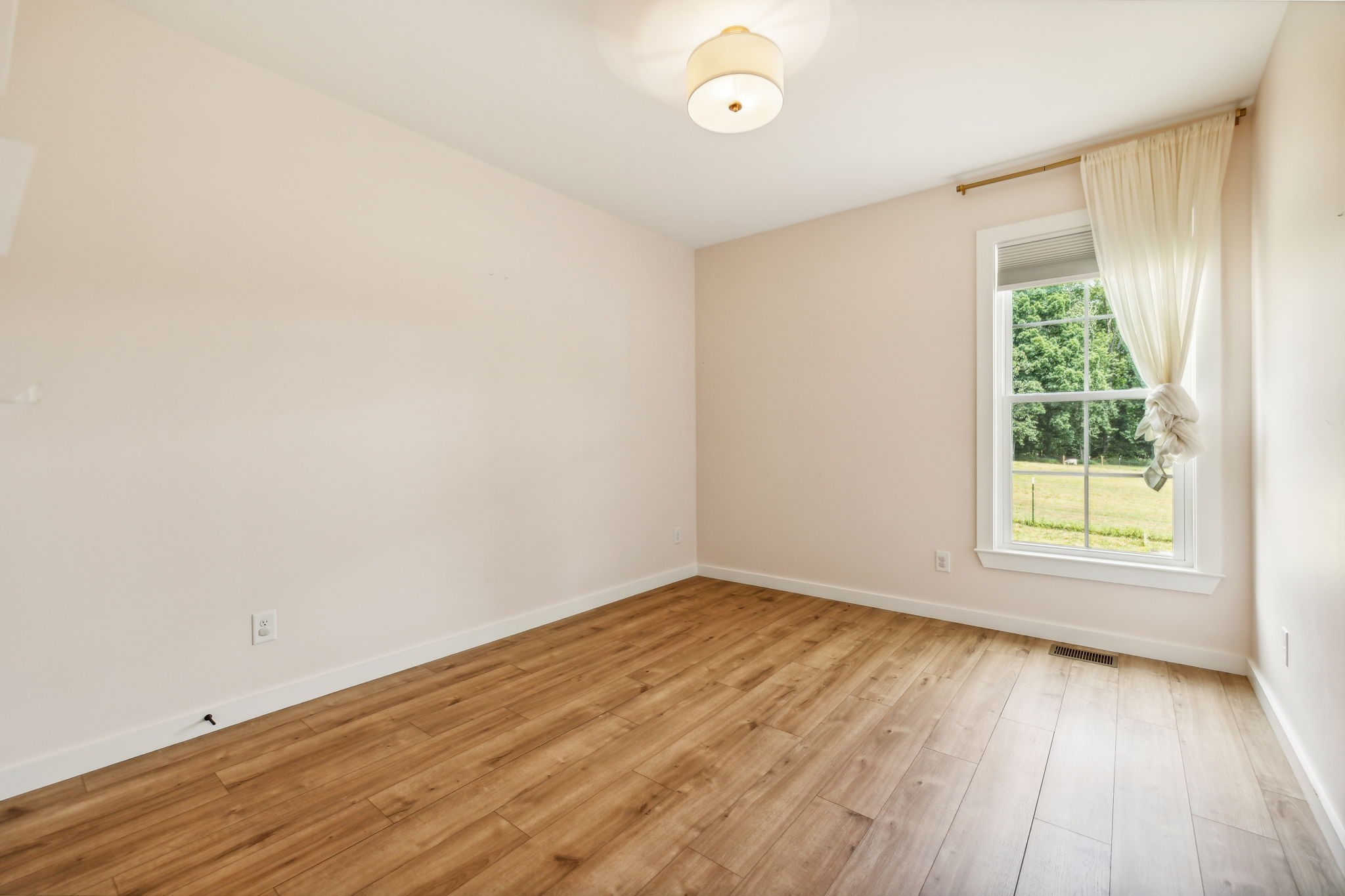 268 Dink Rut Road Portland, TN 37148 - Photo 22 of 40 an empty room with wooden floor and windows