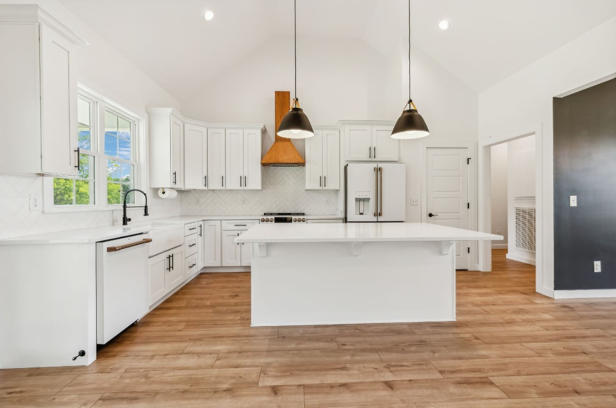 268 Dink Rut Road Portland, TN 37148 - Photo 3 of 40 a large kitchen with stainless steel appliances kitchen island granite countertop a sink a stove a counter space and a window
