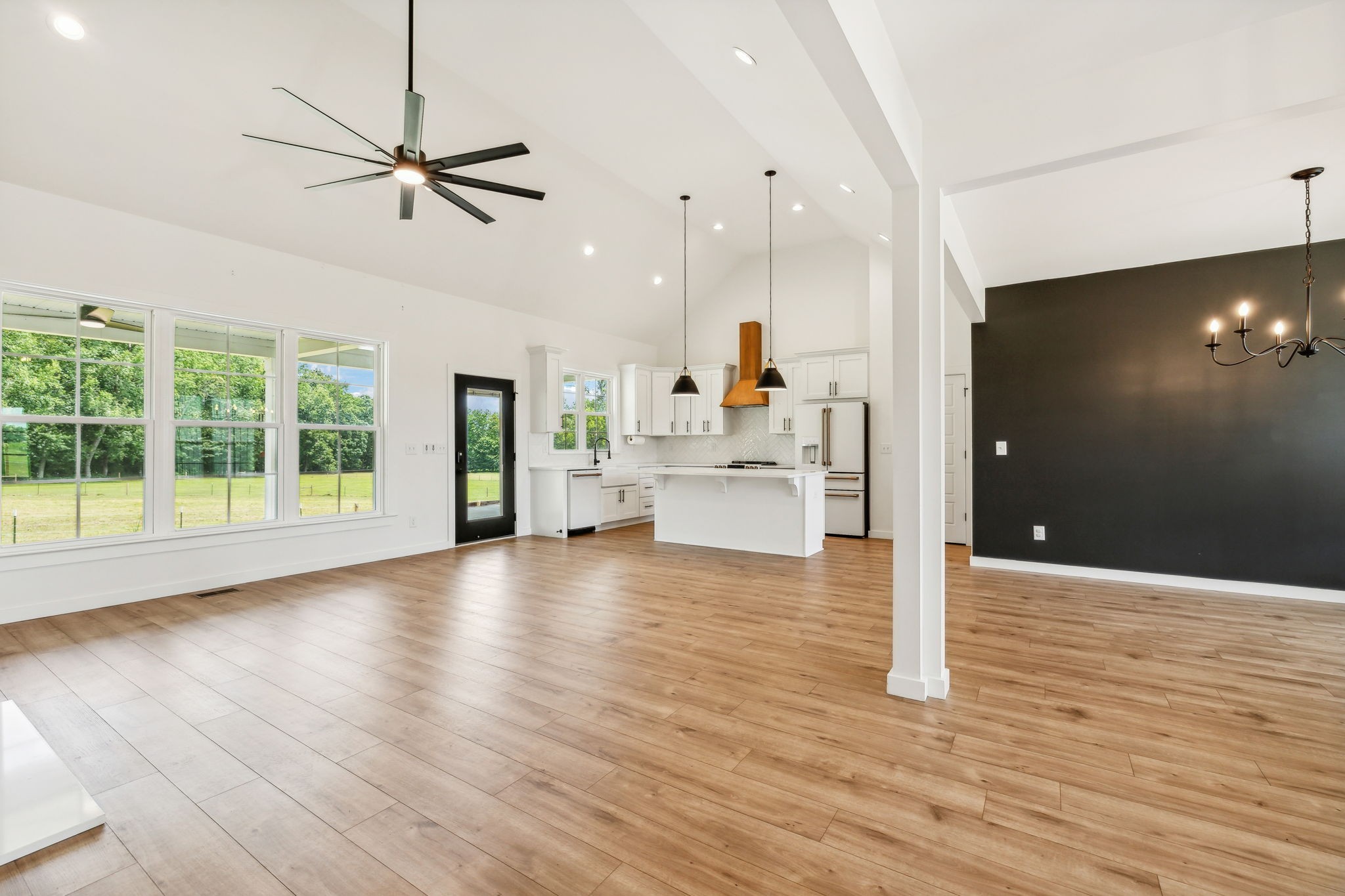 268 Dink Rut Road Portland, TN 37148 - Photo 10 of 40 a view of an empty room with wooden floor and a ceiling fan