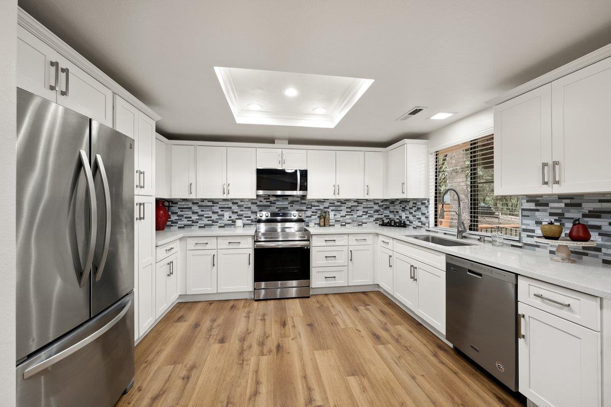 6561 Trinity Way Placerville, CA 95667 - Photo 30 of 58 a kitchen with stainless steel appliances a refrigerator sink stove and cabinets