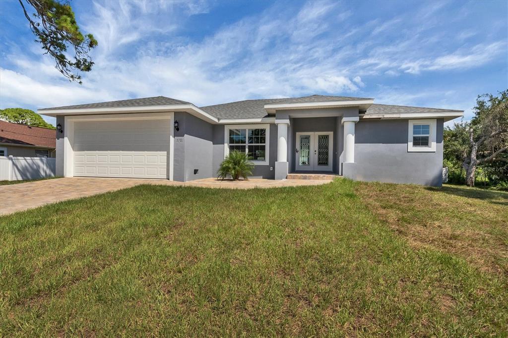 5781 Elton Road Venice, FL 34293 - Photo 1 of 1 a front view of house with yard and trees in the background