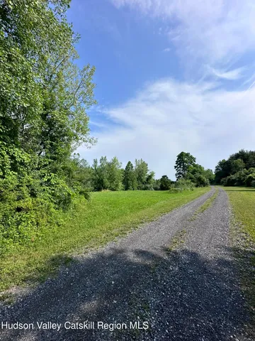 a view of a field and trees