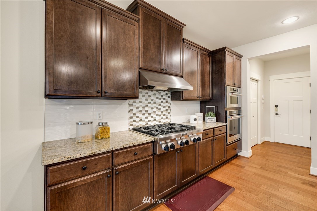 15927 98th Avenue Northeast Bothell, WA 98011 - Photo 12 of 33 a kitchen with stainless steel appliances granite countertop a stove a sink and a refrigerator