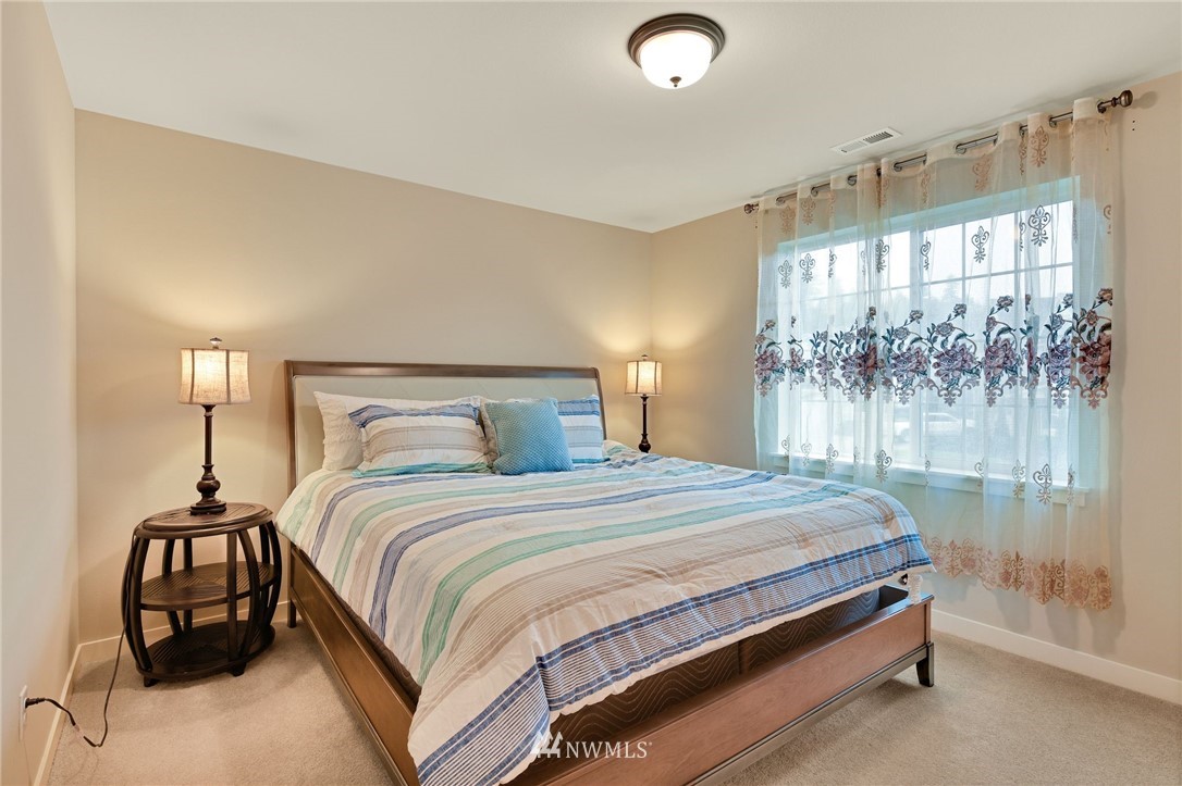 15927 98th Avenue Northeast Bothell, WA 98011 - Photo 13 of 33 a bedroom with a bed and large window