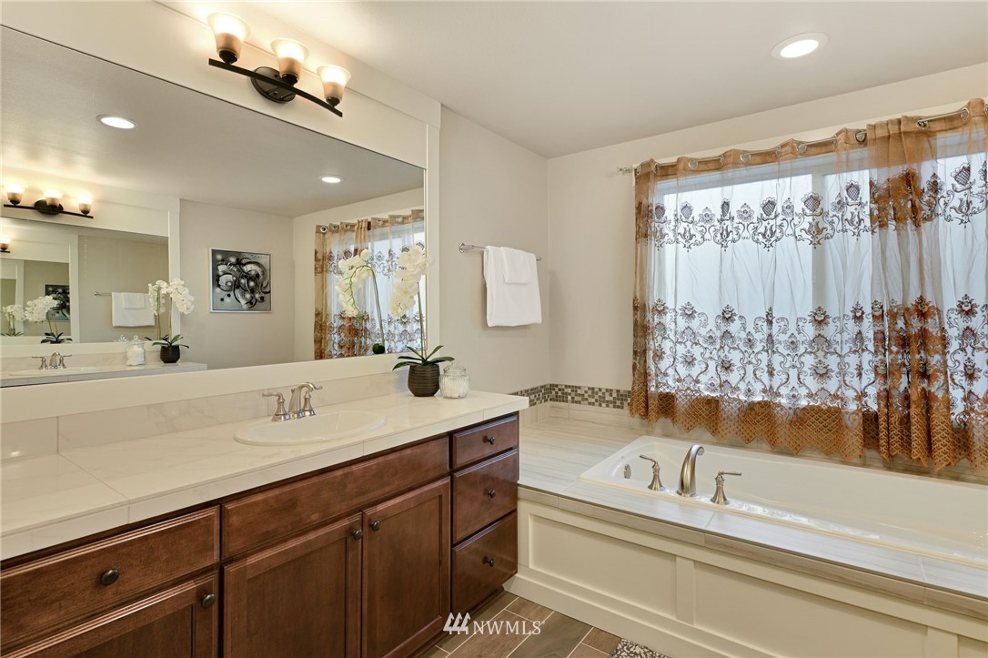 15927 98th Avenue Northeast Bothell, WA 98011 - Photo 19 of 33 a spacious bathroom with a tub sink and mirror