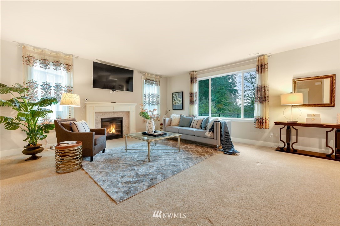15927 98th Avenue Northeast Bothell, WA 98011 - Photo 3 of 33 a living room with furniture a fireplace and a flat screen tv