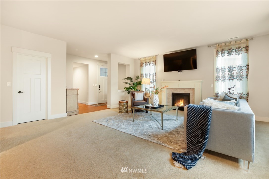15927 98th Avenue Northeast Bothell, WA 98011 - Photo 4 of 33 a living room with furniture a fireplace and a flat screen tv