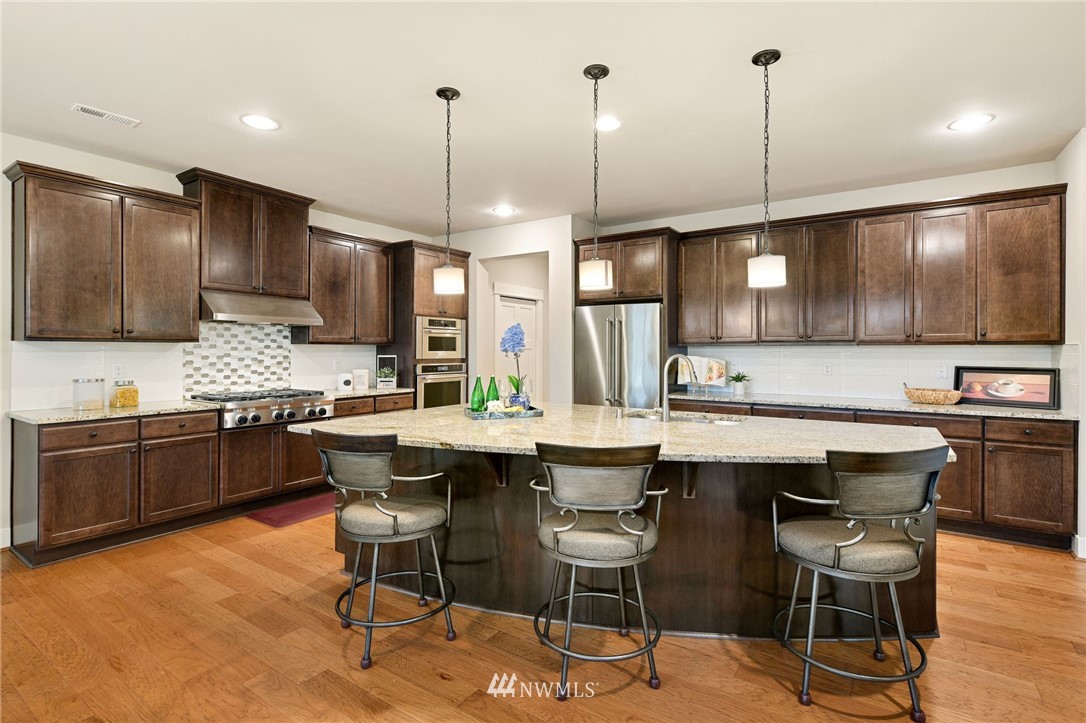 15927 98th Avenue Northeast Bothell, WA 98011 - Photo 9 of 33 a kitchen with a table chairs sink and cabinets
