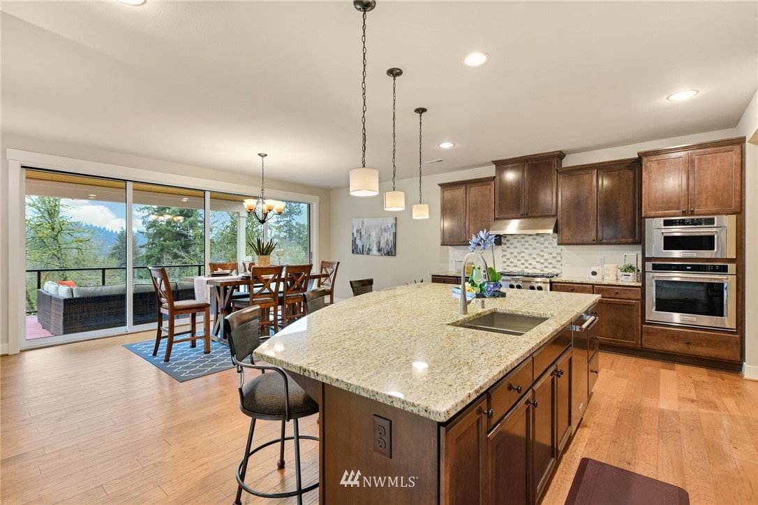 15927 98th Avenue Northeast Bothell, WA 98011 - Photo 10 of 33 a kitchen with stainless steel appliances granite countertop a sink a stove and a refrigerator