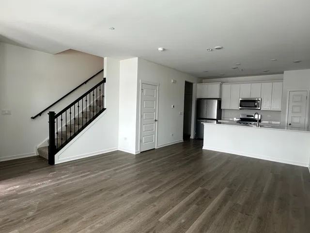 a view of kitchen with wooden floor and electronic appliances