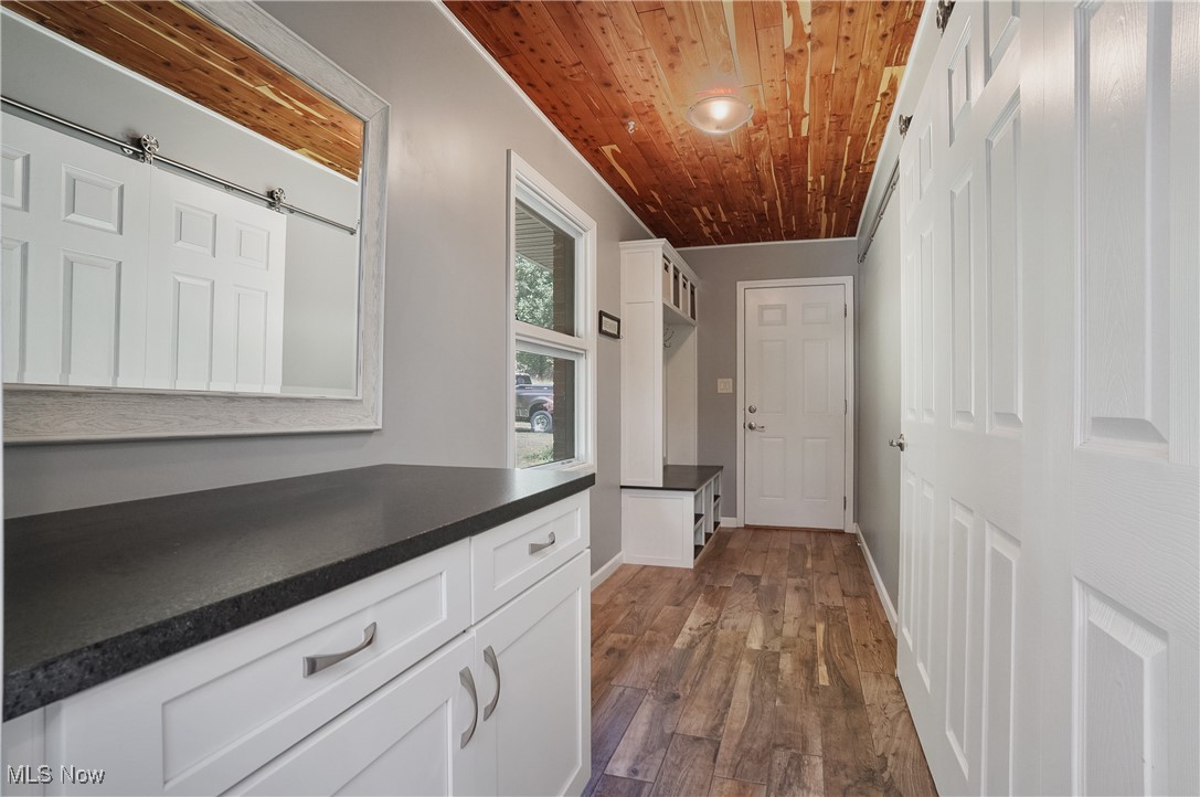4555 Ranchwood Road Akron, OH 44333 - Photo 26 of 43 Hall with dark wood-style floors and wood ceiling