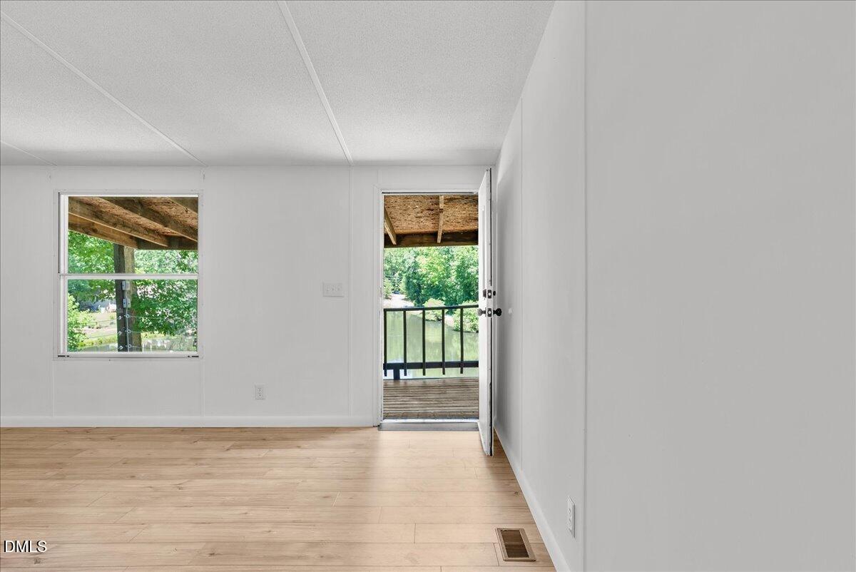 1111 Stoney Mountain Road Rougemont, NC 27572 - Photo 11 of 30 a view of a room with wooden floor and a window