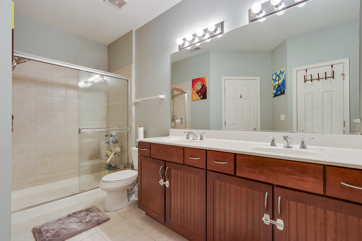 1358 Scarboro Road, Unit 806 Schaumburg, IL 60193 - Photo 13 of 16 a bathroom with a double vanity sink mirror double and shower
