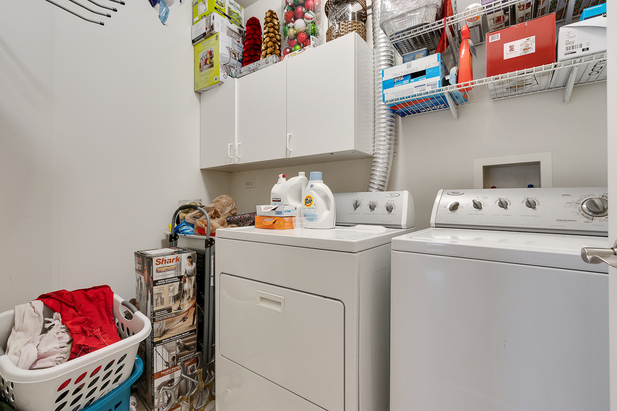 1358 Scarboro Road, Unit 806 Schaumburg, IL 60193 - Photo 15 of 16 a utility room with dryer washer and a fridge
