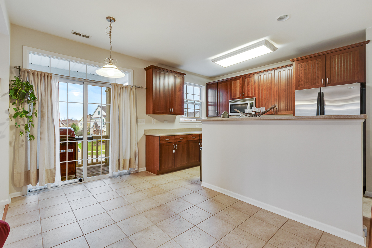 1358 Scarboro Road, Unit 806 Schaumburg, IL 60193 - Photo 3 of 16 a kitchen with stainless steel appliances a refrigerator and a sink