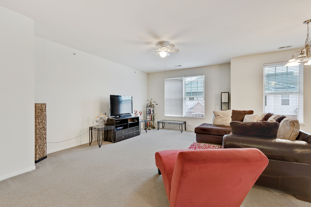 1358 Scarboro Road, Unit 806 Schaumburg, IL 60193 - Photo 8 of 16 a living room with furniture and a flat screen tv