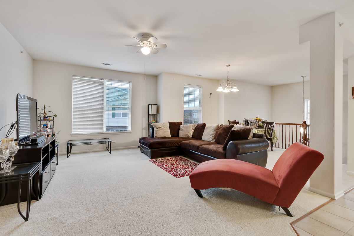 1358 Scarboro Road, Unit 806 Schaumburg, IL 60193 - Photo 9 of 16 a living room with furniture a ceiling fan and a window