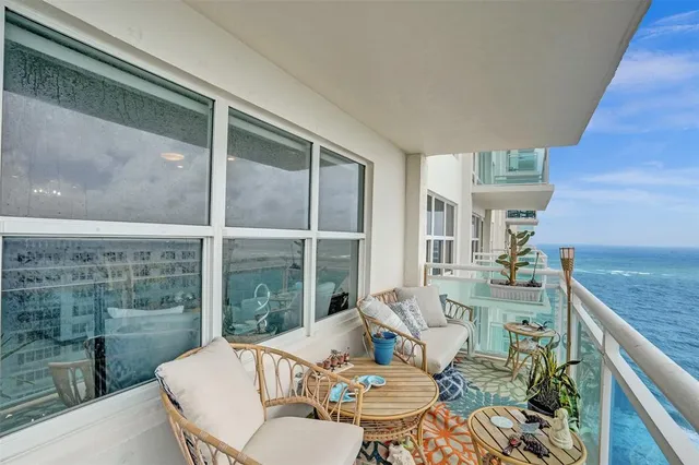 a balcony with furniture and view of city