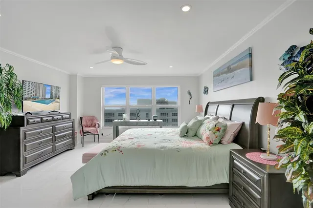a bedroom with a large bed and a large window