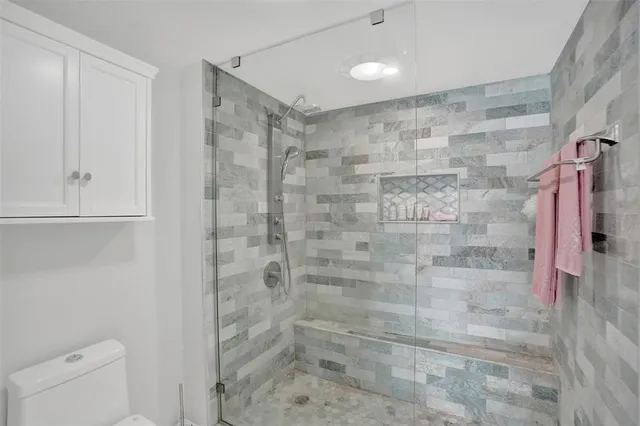 a spacious bathroom with a granite countertop sink a mirror and a