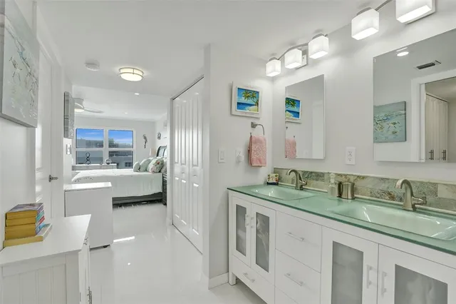 a bathroom with a toilet sink a vanity and mirror