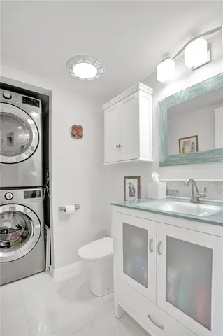 a utility room with sink washer and dryer