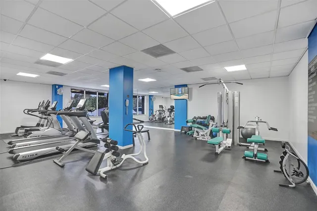 a kitchen with a dining table chairs and white cabinets