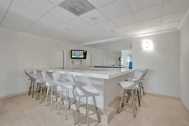 a group of people sitting in front of retail shops