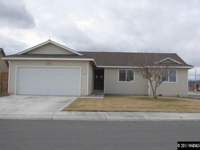 1600 Burger Road Fernley, NV 89408 - Photo 1 of 13 a front view of a house with a garden and garage